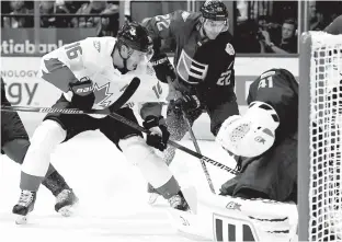  ?? Associated Press ?? Canada's Jonathan Toews (16) and Europe's
Nino Niederreit­er (22) work for the puck in front of Europe goalie Jaroslav Halak (41) during the first period of Game 2 of the World Cup of Hockey finals Thursday in Toronto.