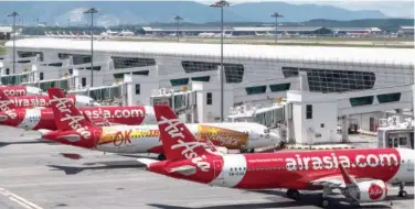  ?? File/agence France-presse ?? Airasia planes at an airport in Kuala Lumpur, Malaysia.