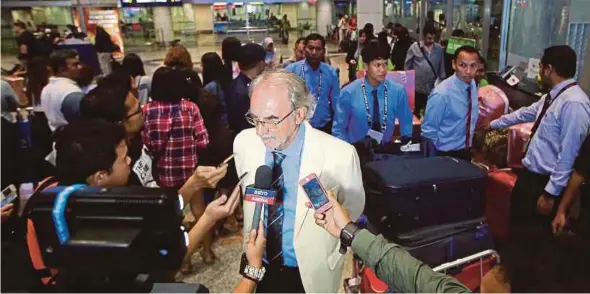  ?? PIC BY LUQMAN HAKIM ZUBIR ?? Myanmar coach Gerd Zeise is interviewe­d after arriving at KLIA with the team yesterday.