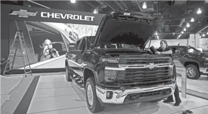  ?? ANGELA PETERSON / MILWAUKEE JOURNAL SENTINEL ?? Jamie Makowski, product specialist for Chevrolet, preps a 2023 Chevrolet Silverado HD for the Milwaukee Auto Show at the Wisconsin Center on Thursday. The show runs Saturday through March 5.