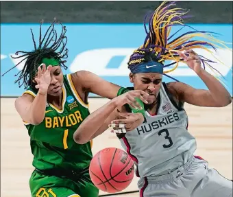  ?? ERIC GAY/AP PHOTO ?? Baylor forward NaLyssa Smith (1) and UConn forward Aaliyah Edwards (3) battle for control of a rebound during the second half of Monday night’s NCAA Elite Eight game at the Alamodome in San Antonio. The Huskies advanced to their 13th straight Final Four with a 69-67 win over the Bears and will face either Arizona or Indiana in Friday’s national semifinal.