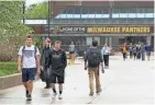  ?? MICHAEL SEARS / MILWAUKEE JOURNAL SENTINEL ?? UW-Milwaukee students walk near the student union. UWM was down 649 students (2.6%) this fall.