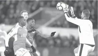  ?? AFP PHOTO ?? Fleetwood Town’s English goalkeeper Chris Neal (right) stops a shot from Leicester City’s Nigerian striker Kelechi Iheanacho (center) during the English FA Cup third round replay football match between Leicester City and Fleetwood Town at King Power...