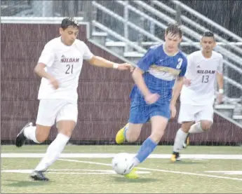  ?? Graham Thomas/Siloam Sunday ?? Siloam Springs junior Christian Marroquin, left, dribbles as Harrison’s Corbin Simpson and Panthers junior Gerson Matias give chase on the play during Tuesday’s 5A/6A District 1 boys soccer match at Panther Stadium.