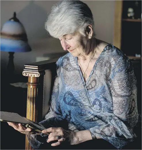  ?? CRAIG ROBERTSON / POSTMEDIA NEWS ?? Holocaust survivor Hedy Bohm looks at notes from her parents in a memory book that survived the Second World War. It is only since 2007 that the retired shoe-store owner has agreed to speak to students about her past.