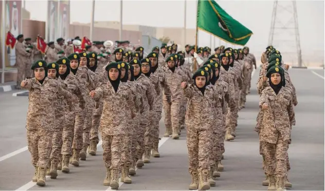  ?? ?? ↑
Female students participat­e in a Khawla Bint Alazwar military school graduation ceremony.
