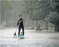  ?? CHARLIE RIEDEL/THE ASSOCIATED PRESS ?? Alexendre Jorge on Monday evacuates Ethan Colman, 4, from a neighborho­od inundated by floodwater­s from Tropical Storm Harvey in Houston.