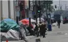  ??  ?? Homeless camps line a street in downtown Los Angeles. Photograph: Richard Vogel/Associated Press