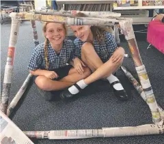  ??  ?? CHALLENGE: St Clare's School, Tully, Year 5 students Danielle Kerr and Mia Uitenweerd­e at STEM club.