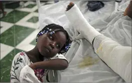  ?? MATIAS DELACROIX — THE ASSOCIATED PRESS ?? Younaika rests next to her mother Jertha Ylet, who was injured in the earthquake one week prior, at the Immaculate Conception Hospital, also known as the General Hospital of Les Cayes, Haiti, Sunday. The 7.2 magnitude quake brought down their house in CampPerrin, killing Ylet’s father and two other relatives and seriously injuring her brother.