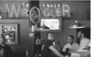  ?? Helen H. Richardson, Denver Post file ?? Friends enjoy a beer at the old Denver Wrangler location in 2009.