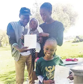  ??  ?? AT LAST. Primrose Moyo, a friend, and daughters Nosipho, front, and Ayanda with their SA birth certificat­es acquired through the court.