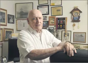  ?? BEN HASTY — MEDIANEWS GROUP ?? Korean war veteran Paul A. Miller in his Hamburg home with photos and medals from his time in the Navy.