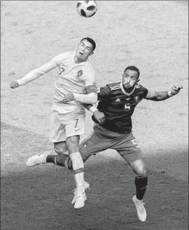  ?? Juan Mabromata AFP/Getty Images ?? PORTUGAL FORWARD Cristiano Ronaldo soars over Morocco’s Mehdi Benatia as he vies for a header Wednesday. Ronaldo has 85 career goals with Portugal.