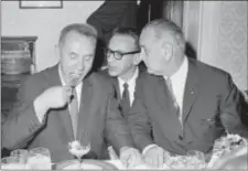  ?? JERRY MOSEY — THE ASSOCIATED PRESS FILE ?? In this file photo, Soviet Premier Alexi Kosygin takes a bite of shrimp cocktail as State Department Interprete­r, Bill Kramer, center, relays the words of President Lyndon Johnson, right, during a luncheon meeting of the leaders on the Glassboro State...