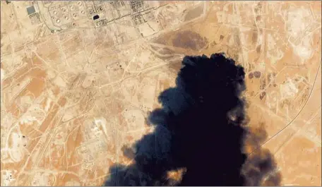  ?? Planet Labs Inc. ?? A SATELLITE image from Saturday shows smoke rising from the Abqaiq oil processing facility in Saudi Arabia. Houthi rebels in Yemen took responsibi­lity, but the Saudi Foreign Ministry said Monday that the attack involved “Iranian weapons.” It provided no details.