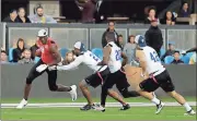  ?? Marcio Jose Sanchez / The Associated Press ?? Team Owens’ Terrell Owens (left) carries the ball after a catch during a flag football exhibition game in San Jose, Calif.