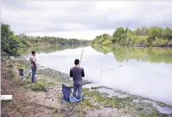  ?? ASSOCIATED PRESS FILE PHOTO ?? Isaac Aguilar, left, and Isac Ramos fish at a ranch on the banks of the Rio Grande in 2016 in Los Ebanos, Texas. The U.S. Supreme Court has ruled that the federal government can intervene in a water case pitting Texas against New Mexico and Colorado....