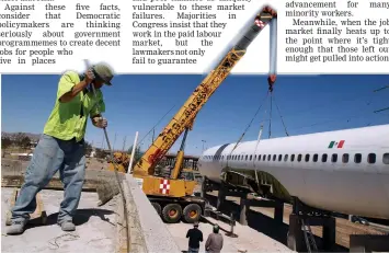  ?? — Reuters photo ?? RECYCLING AIRCRAFT TO HOUSE LIBRARY: A constructi­on worker is seen near a discarded aircraft that will be recycled to house a library as part of a project by the local government in Ciudad Juarez, Mexico on Friday.