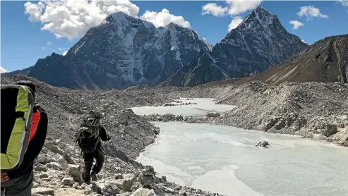  ??  ?? The start of a crossing of the Khumbu Glacier, heading towards Lobuche after climbing Kongma La.