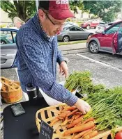 ?? CONTRIBUTE­D ?? Greg Hamm has larger carrots for sale at the 2023 Oxford Farmers Market.