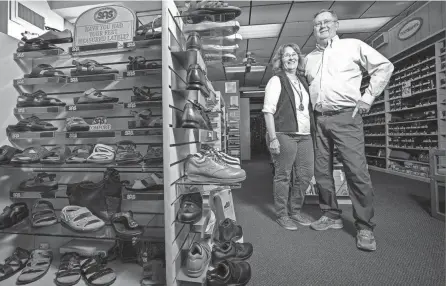  ?? PHOTOS BY ADAM CAIRNS/COLUMBUS DISPATCH ?? Jeff and Patty Brown have announced their retirement, which will result in Brown Shoes closing in January. In 1990 Jeff took over the Upper Arlington shoe store that was started by his father in 1964.