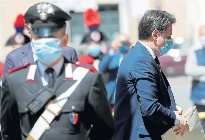  ?? /Reuters ?? Pandemic politics: Italian Prime Minister Giuseppe Conte, who has been criticised by smallbusin­ess owners, wears a mask as he arrives to attend a session of the senate in Rome, Italy, on April 30.