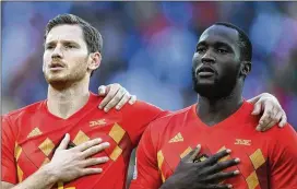  ?? LAURENCE GRIFFITHS / GETTY IMAGES ?? Jan Vertonghen and Romelu Lukaku of Belgium sing the national anthem prior to the World Cup semifinal match against France at St. Petersburg Stadium on Tuesday in St. Petersburg, Russia.