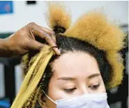  ?? PAUL W. GILLESPIE/CAPITAL GAZETTE PHOTOS ?? Djuiko works on Jackson’s hair. The salon offers its signature style — hip length, knotless box braids — for about $170 to $180, and it can be done in about two to three hours.
The cost and speed are unheard of in the braiding industry, Djuiko says.