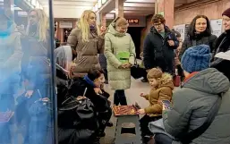  ?? ?? A boy and a woman play chess in a subway station being used as a bomb shelter during a Russian rocket strike on Kyiv yesterday, part of a wave of attacks across Ukraine.