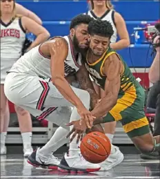  ?? Peter Diana/Post-Gazette ?? Duquesne’s Marcus Weathers, left, runs into George Mason’s Xavier Johnson going for a loose ball Saturday night at UPMC Events Center.
