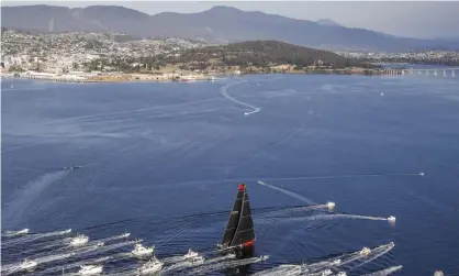  ?? Photograph: Carlo Borlenghi/ROLEX/AFP via Getty Images ?? Supermaxi yacht Comanche has won the Sydney to Hobart yacht race for the third time, crossing the finish line just after 7.30am on Saturday morning.