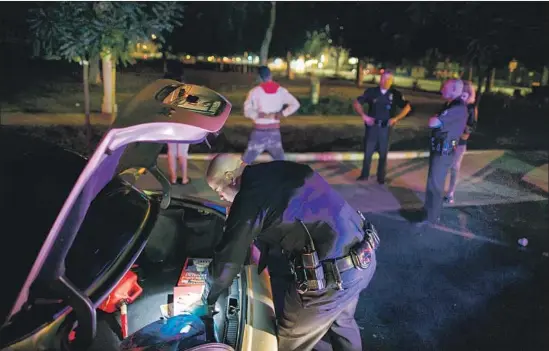  ?? Marcus Yam Los Angeles Times ?? OFFICERS from the LAPD’s then-newly expanded Metropolit­an Division search the trunk of a motorist’s vehicle during a stop in Los Angeles in November 2015.