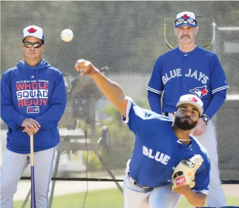  ?? NATHAN DENETTE/THE CANADIAN PRESS ?? New Toronto Blue Jays manager Charlie Montoyo and pitching coach Pete Walker watch Hector Perez work out as the team kicks off spring training this week in Dunedin, Fla. The Jays will trot out a young lineup this season with several veterans having moved on.