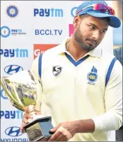  ??  ?? Delhi team captain Rishabh Pant with Runners-up trophy after their final against Vidarbha in Indore on Monday.