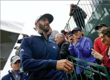  ?? CAROLYN KASTER — THE ASSOCIATED PRESS ?? Dustin Johnson heads for the 14th tee during a practice round for the U.S. Open on June 13 in Southampto­n, N.Y.