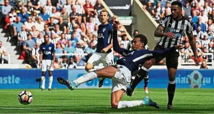  ?? — AFP ?? Stretch and score: Tottenham Hotspur’s Dele Alli scoring the first goal against Newcastle in the English Premier League match at St James’ Park on Aug 13. Tottenham won 2- 0.