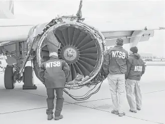  ?? NTSB via Associated Press ?? National Transporta­tion Safety Board investigat­ors examine damage to the engine of the Southwest Airlines Boeing 737 that made an emergency landing in Philadelph­ia last month.