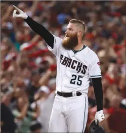  ?? The Associated Press ?? Arizona Diamondbac­k’ pitcher Archie Bradley celebrates his two-run triple against the Colorado Rockies during the seventh inning of the National League wild-card playoff baseball game on Wednesday in Phoenix.