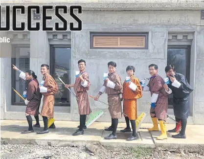  ??  ?? ABOVE Bhutan Toilet Organizati­on volunteers prepare to clean a public toilet.