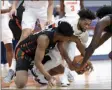  ?? DENNIS NETT ?? Miami guard Earl Timberlake, left, Syracuse forward Alan Griffin (0) and Miami center Nysier Brooks (3) scramble for a loose ball during an NCAA college basketball game Tuesday, Jan. 19, 2021 in Syracuse, N.Y.