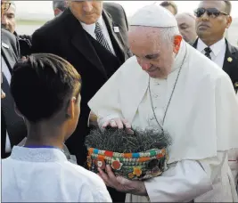  ?? Andrew Medichini ?? The Associated Press Pope Francis is offered a basket of Bangladesh soil as he arrives Thursday at
Dhaka’s internatio­nal airport.