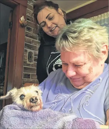  ?? CARLA ALLEN ?? Margaret Earle greets Buddy after his long trip from Guelph, Ontario, as daughter Stephanie looks on.