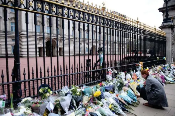  ?? (EPA) ?? Flowers and messages of condolence­s are left by mourners in tribute to Prince Philip, who passed away peacefully yesterday