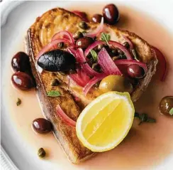  ?? Kirsten Gilliam ?? Trattoria Sofia’s menu includes a pan-seared swordfish with olives, capers, pine nuts and lemon.