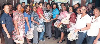  ??  ?? Members of the teaching staff of Free Town Primary School smile on being presented with their gift baskets by the team from Jamaica Broilers Group.