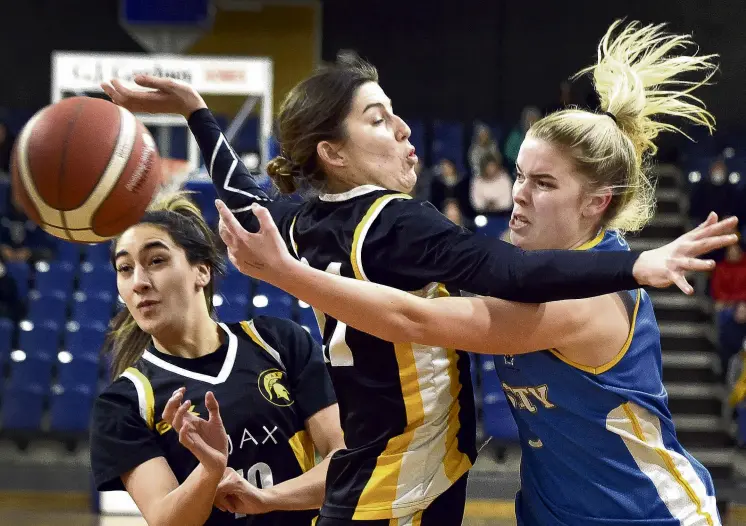  ?? PHOTO: PETER MCINTOSH ?? Contact sport . . . Varsity guard Caitlin O’Connell looks to pass through the contact from Ajax forward Bronwyn Kjestrup, while Dre Whaanga watches on, during the Dunedin women’s club basketball final at the Edgar Centre on Tuesday night.