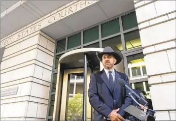  ?? GEMUNU AMARASINGH­E AP ?? Otero County Commission­er Couy Griffin speaks to reporters at federal court in Washington on Friday. Griffin voted by phone against certificat­ion of recent primary election results in his county in New Mexico.