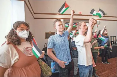  ?? ALICIA DEVINE/TALLAHASSE­E DEMOCRAT ?? Florida State University Students for a Democratic Society and other organizati­ons attend an FSU Board of Trustees meeting where they waived Palestinia­n flags and chanted before being escorted out by the FSU Police Department on Nov. 10.