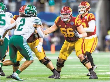  ?? Matthew Visinsky Icon Sportswire via Getty Images ?? USC OFFENSIVE LINEMAN Gino Quinones (66) blocks during the Cotton Bowl against Tulane in January. He has been with the Trojans since 2019, a reliable reserve with two starts under his belt from last season.